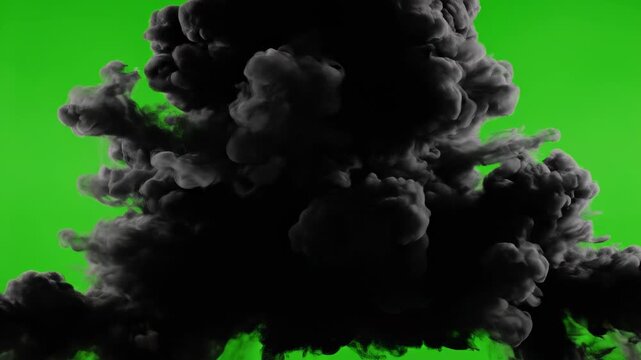 Explosion cloud of dense black smoke and dust erupting outwards on a green screen background, ideal for special effects and compositing