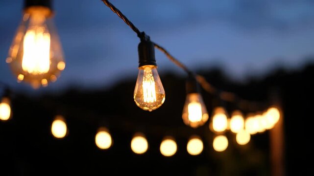 String lights illuminate a twilight gathering, creating a warm and inviting ambiance