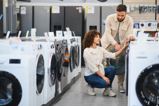 Couple exploring home appliances in electronics store