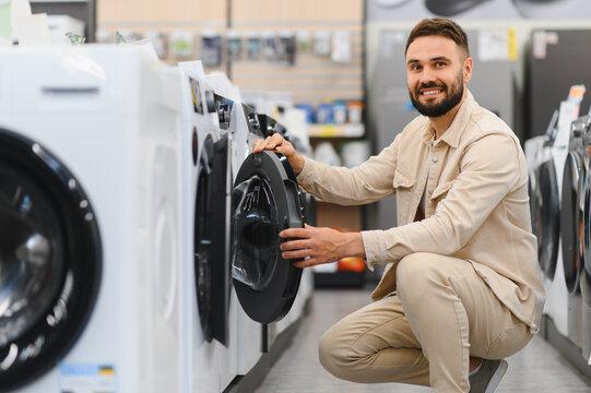 Customer choosing washing machine in electronics store