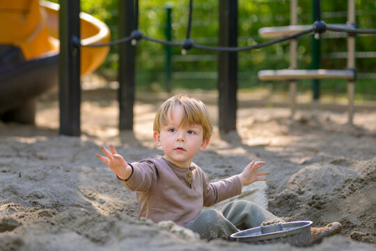 Toddler Playing Freely In Sandbox