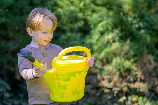 Toddler Holding Bright Yellow Wateringcan