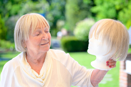 Senior Woman Holding Blonde Wig