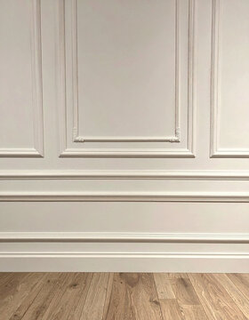 Classic white wall moldings elegant wainscoting interior design minimalist aesthetic wooden flooring smooth texture sophisticated room detail clean architectural style neutral decor home luxury backgr