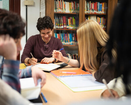 University students collaborating and learning during a group study session in a library