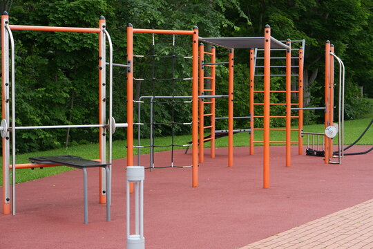 Modern outdoor fitness sports ground with workout bars and ropes