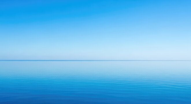 A peaceful view of a calm blue ocean stretching towards a perfectly flat horizon under a vast, cloudless sky during a bright, sunny day, ripple, sky, horizon