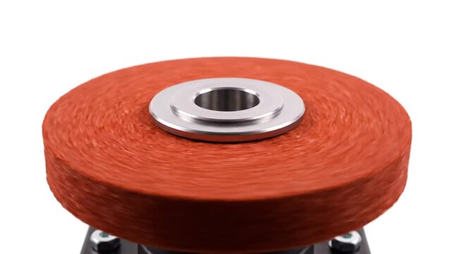 Close-up of a rotating abrasive grinding wheel on a white background, industrial tools