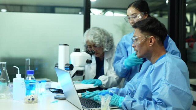 Professional ecologists testing wastewater purity using scientific equipment in sterile cleanroom, environmental sustainability concept.