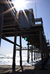 Fototapeta premium Wooden pier structure with sunlight and ocean waves