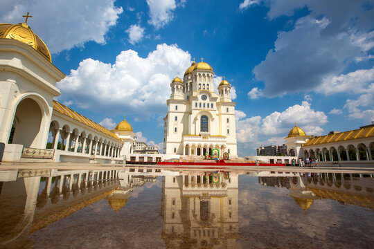 Symmetrical reflection of the Romanian Peoples Salvation Cathedral in a water puddle in Bucharest Romania