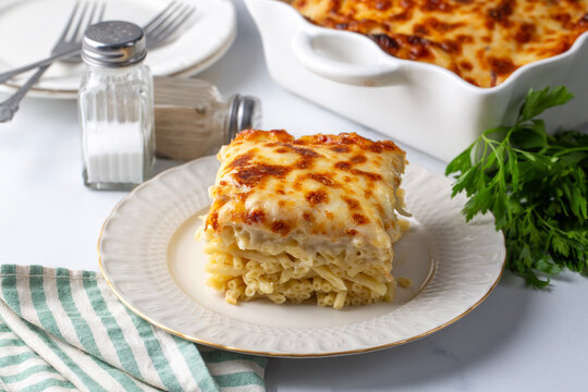 A square slice of baked macaroni with melted cheese - Turkish name; firin makarna