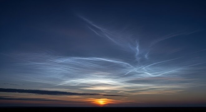 Ethereal noctilucent clouds glowing at twilight sky