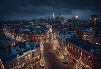 Fototapeta premium Aerial view of city street decorated with Christmas lights at night