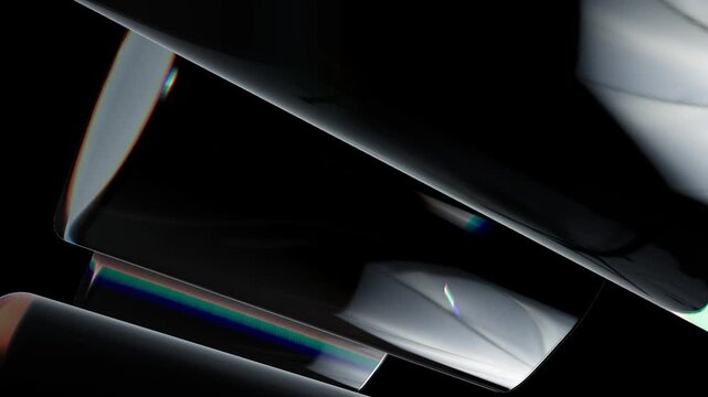 Abstract dark background with smooth glossy curved shapes and glowing rainbow light reflections