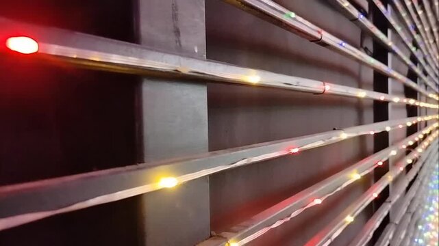 Colorful RGB LED strip lights mounted on metal frame background for party, event, or stage decoration.