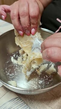 Woman's hands preparing salted cod fish for cooking