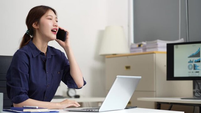 Lifestyle Happy woman speaking to mobile phone and working on laptop computers, online business, work from home, teleworking concept.