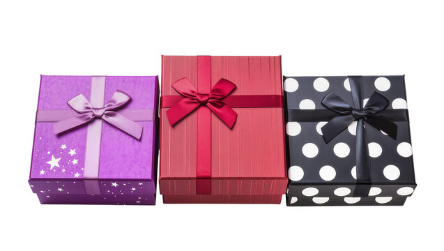 Isolated festive assortment of three colorful present boxes with shiny ribbons and beautiful bows