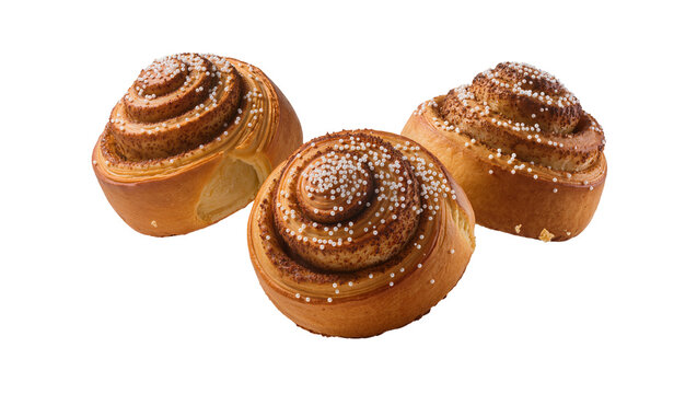Isolated three delicious freshly baked cinnamon buns with sugar pearls, sweet bakery treat dessert