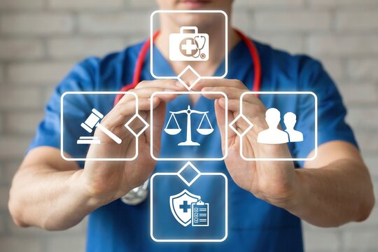 Medical professional holding digital health law icons
