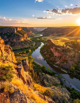 Serene river winds through a canyon at sunset