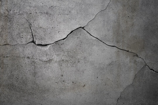 Damaged gray cracked concrete wall background for design.