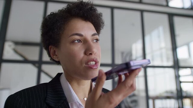 Businesswoman Using Smartphone Voice Assistant in Office