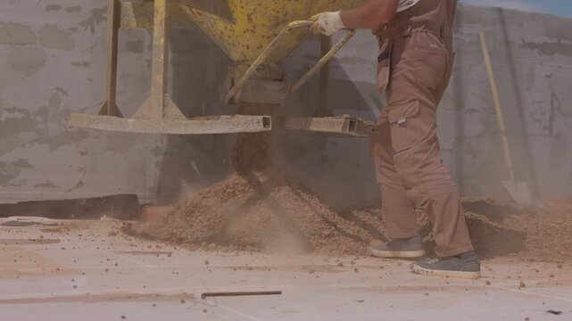 Pouring expanded clay aggregate onto flat roof for thermal insulation