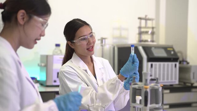  environmental scientists analyzing water quality samples with centrifuge and petri dish in laboratory.