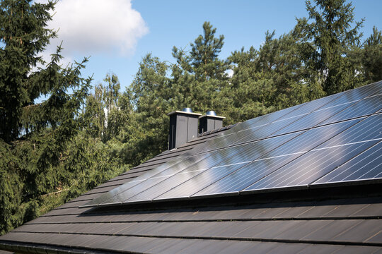 Photovoltaic panels on the house roof. Electricity generation.
