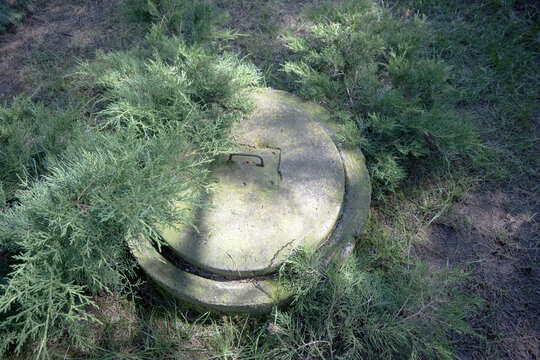 Concrete septic tank in front of a single-family house.