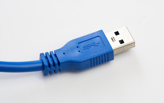 Blue USB 3.2 SuperSpeed Type-A cable connector with SS marking, close-up macro of a modern high-speed data transfer and charging plug on white background with copy space, no people