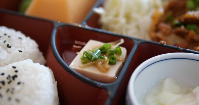 Close up of cold tofu side dish in a bento box