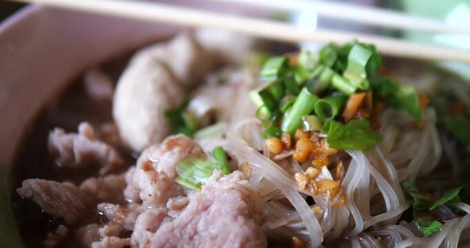 Close up of Thai rice noodles in thick pork blood soup