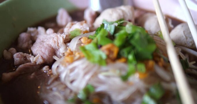Close up of Thai rice noodles in thick pork blood soup