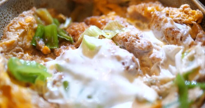 Close up of Japanese Katsudon pork cutlet rice bowl with egg