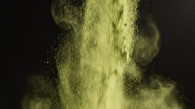 Close up photorealistic shot of fine bright green matcha powder falling gently