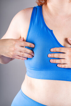 Breast test, woman in blue bra examining her breasts for cancer, mastitis ore mastopathy disease