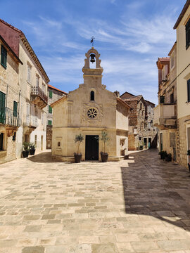 Small church on square of small urban village of Stari grad on Hvar island in Croatia, Adriatic Sea, Europe