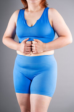 Woman checking her abdomen for diastasis recti, abdominal muscle separation postpartum recovery concept
