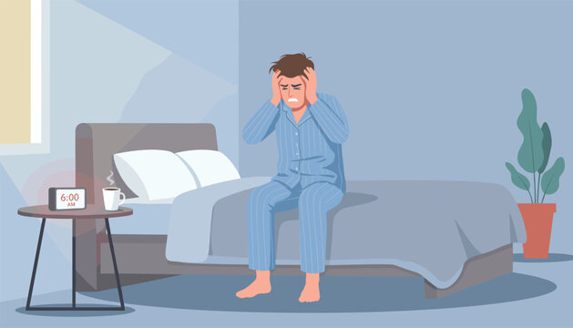 Man sitting on his bed at six in the morning feeling stressed and overwhelmed with his hands on his head in a bedroom setting.
