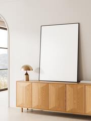 Fototapeta na wymiar Minimal interior scene with large blank poster leaning on wooden cabinet beside modern lamp in bright room with soft daylight and clean design. 3D Rendering