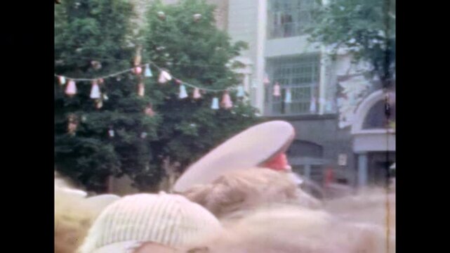 People crowd gathering in city square in central Kyiv, Ukraine. Public celebration event with decorations. Large outdoor gathering at cultural festival. Old film. Archival retro 1982. Vintage archive 