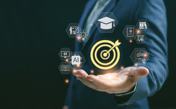 Businessman holding target goal icon with graduation cap, AI learning and education graphics, concepts of corporate training, personal development and smart technology achievement.