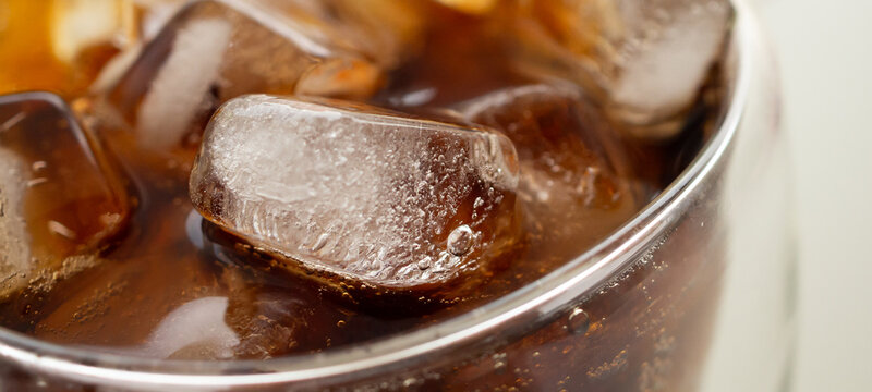 Macro Close Up of cola bubbles and ice cubes background