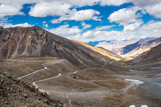 Winding dirt road and hairpin turns in a mountain valley of Ladakh