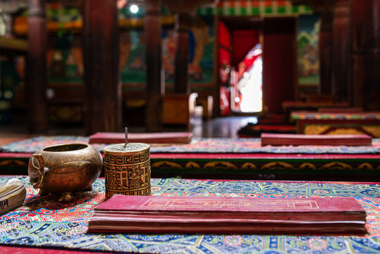 Buddhist ritual objects and manuscripts on a bench at Hemis Monastery