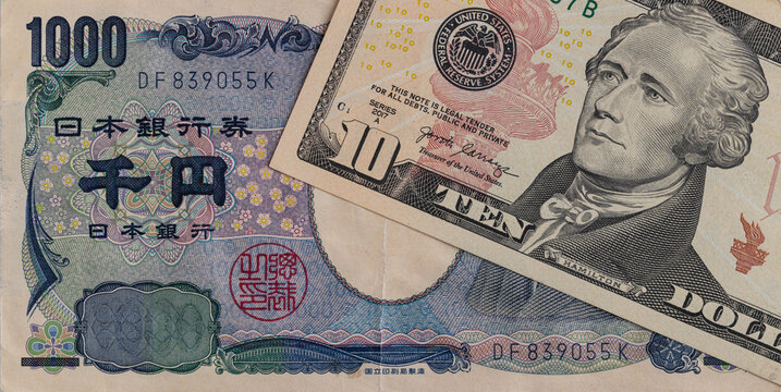 Japanese 1000 yen banknote and US 10 dollar banknote close up