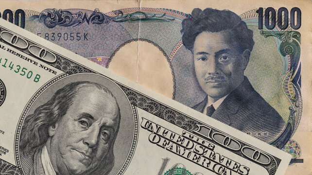 Japanese 1000 yen banknote and US 100 dollar banknote close up